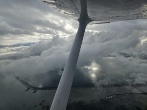 View above the clouds during an Axiom Aviation training flight – How to Get an Aerial Survey Pilot Job