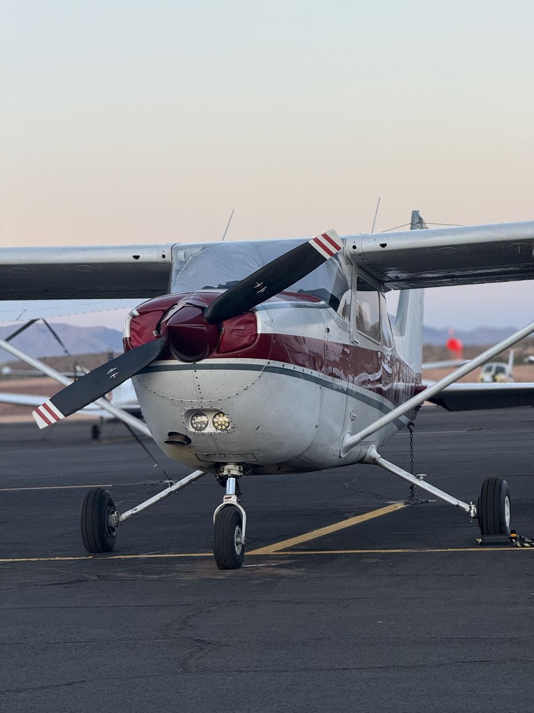 An Axiom Aviation Cessna training aircraft on the ramp at sunset