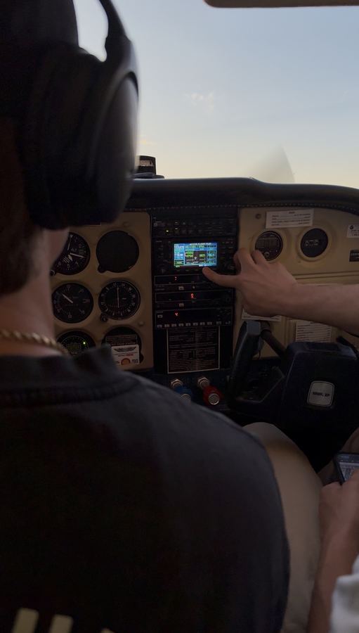 View from the cockpit as an instructor guides a student during a flight