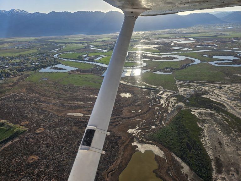 Aerial view of the valley below from an Axiom Aviation Cessna – How Many Hours to Get a Private Pilot License?