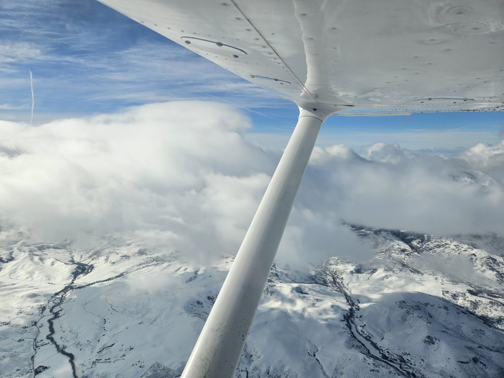 View above the clouds during an Axiom Aviation training flight – How to Get a Flight Training Loan