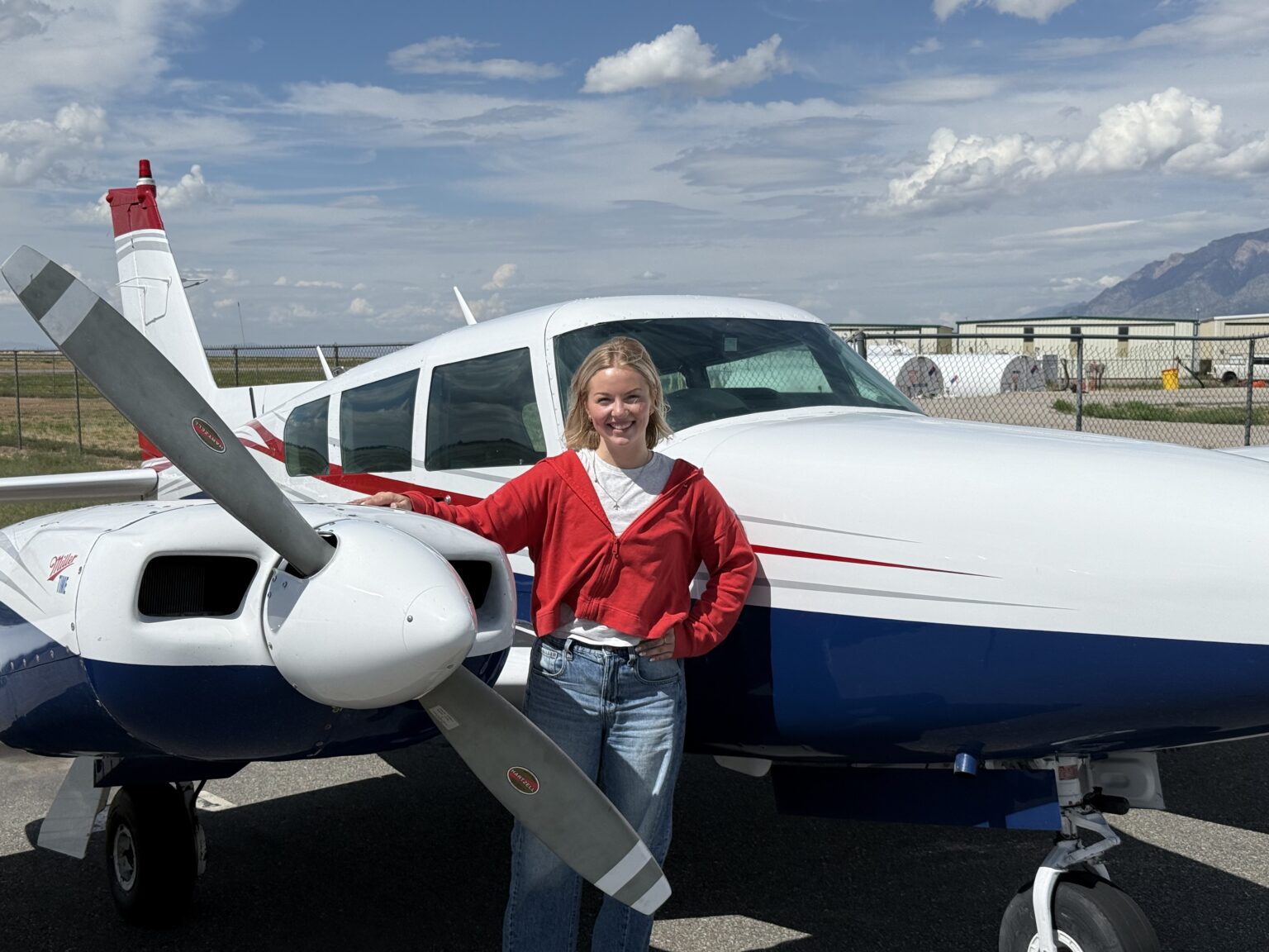 Axiom Aviation student pilot standing beside a twin-engine training aircraft