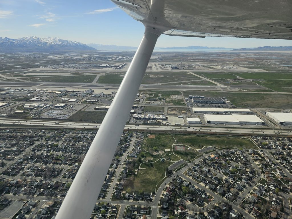Aerial view of the valley below from an Axiom Aviation Cessna – How to Earn a Professional Pilot Degree