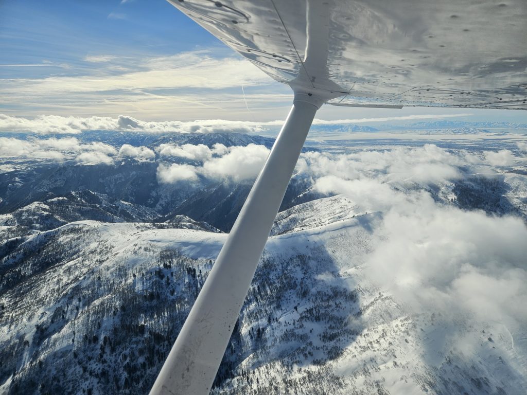 Aerial view of snow-covered Utah mountains from an Axiom Aviation training aircraft – Night Flying Requirements