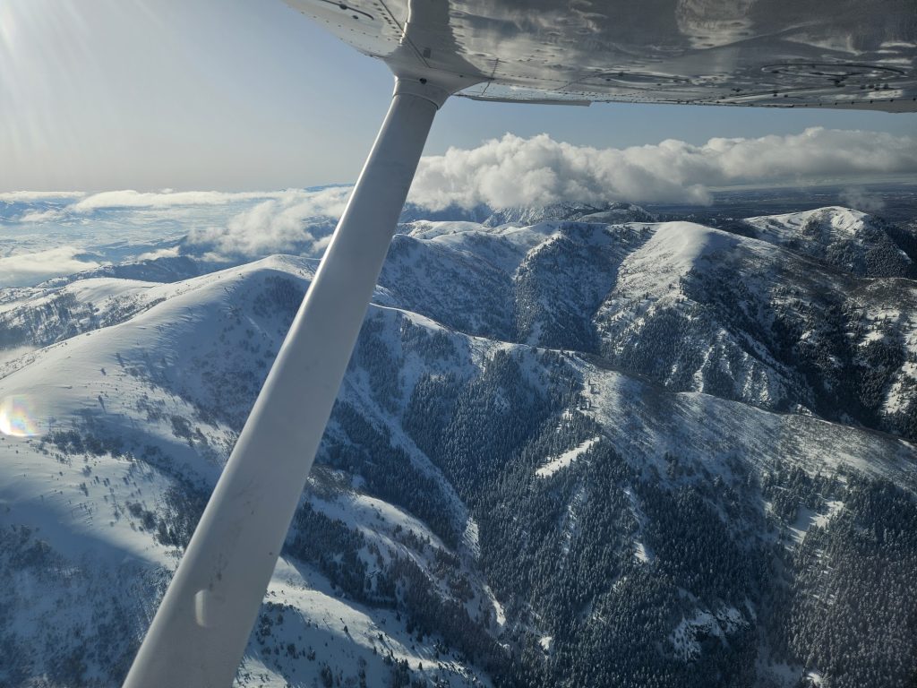 Aerial view of snow-covered Utah mountains from an Axiom Aviation training aircraft – How to Become a Pilot Without a Degree